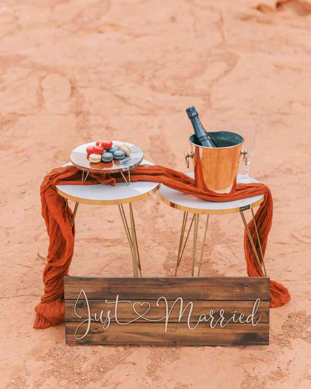 Table décorative de mariage avec panneau “Just Married”, champagne et macarons – Crédit photo Pretty Day